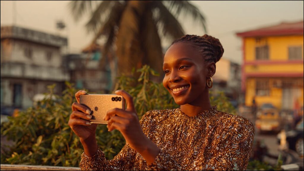Young Nigerian female content creator filming an Instagram Reel on a smartphone outdoors in Lagos