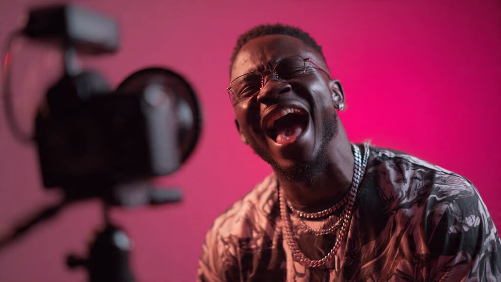 Nigerian content creator filming a Reel in Lagos with bold on-screen captions and trending Afrobeats audio