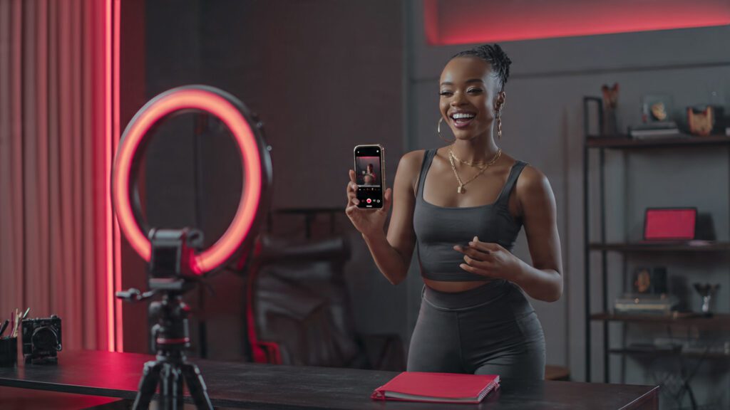 Nigerian creator filming vertical Reels video for Instagram with Afrobeats audio