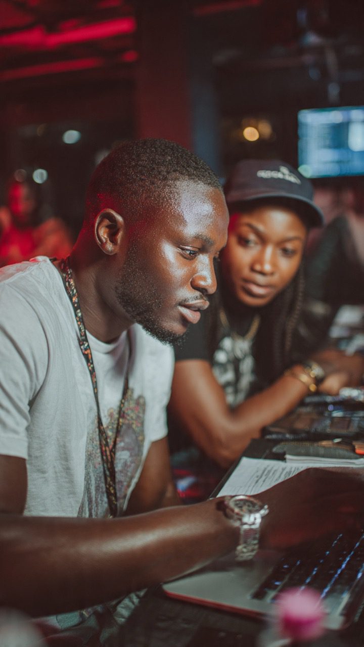Nigerian entrepreneur checking social media promotion dashboard