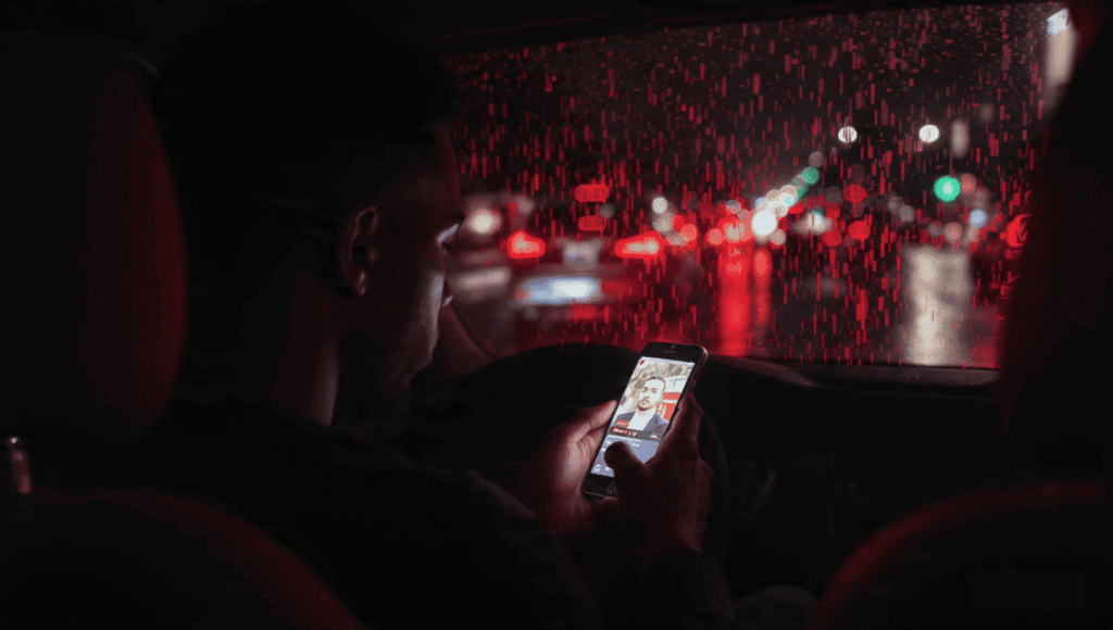 Nigerian professional checking peak hours Reels views during a night commute.