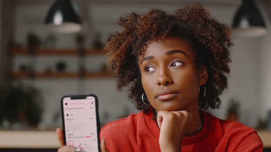 Nigerian Instagram creator checking Reel engagement and comment count on phone