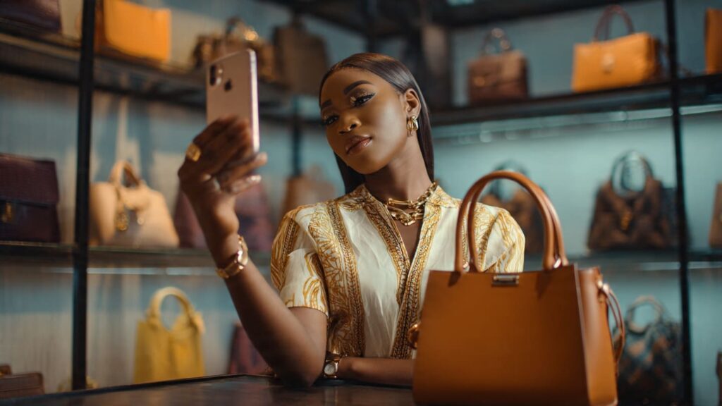 Fashion vendor in a Lagos boutique geotagging a post to get more Instagram Reel views in Nigeria.