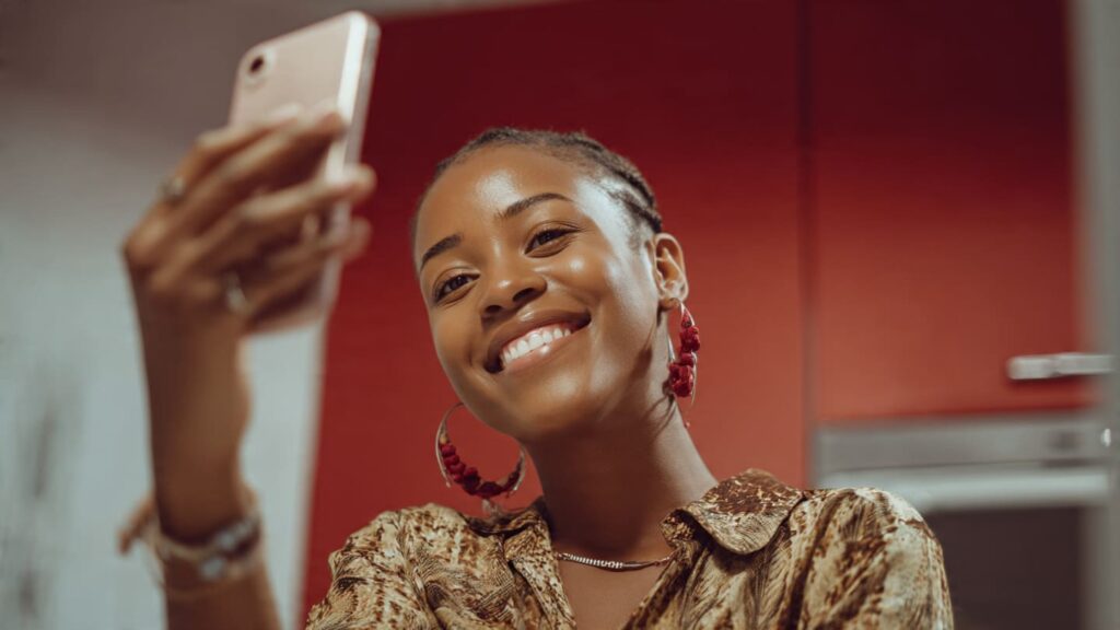 A Nigerian woman capturing a "day in the life" photo to maintain consistent Instagram posting habits for Nigerians.