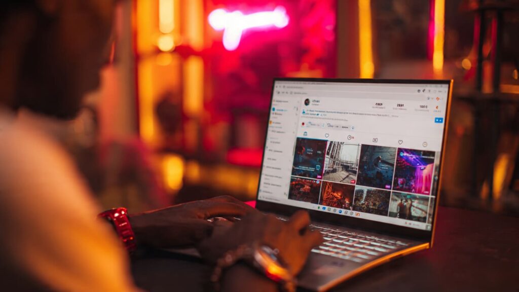 A close-up of a laptop screen displaying high engagement metrics to increase profile taps Instagram for a growing boutique.