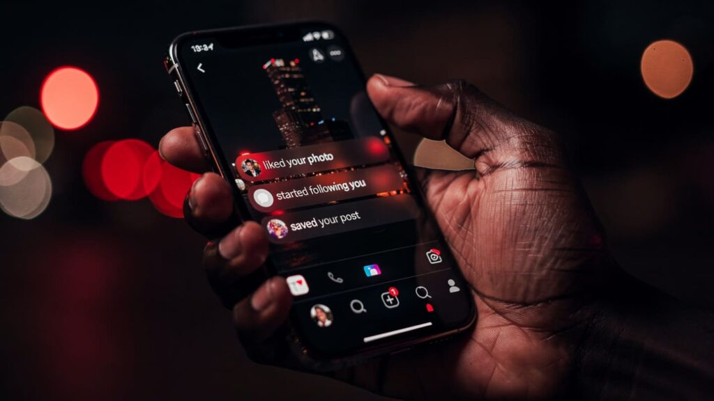 A Nigerian business owner seeing a notification surge to boost Instagram reach in Nigeria.